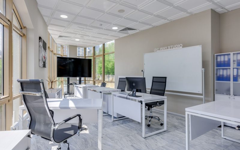 Spacious and bright modern office interior with sleek furniture, ideal for professional workspaces.